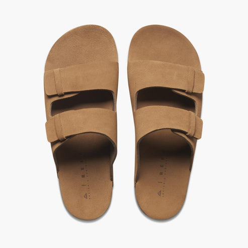 A pair of tan sandals with two straps.