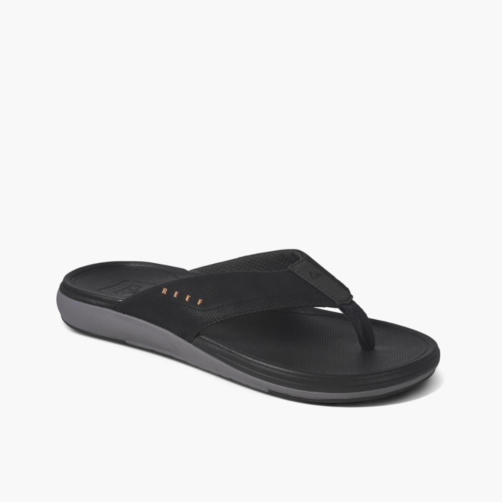 A black sandal thong with gray sole.