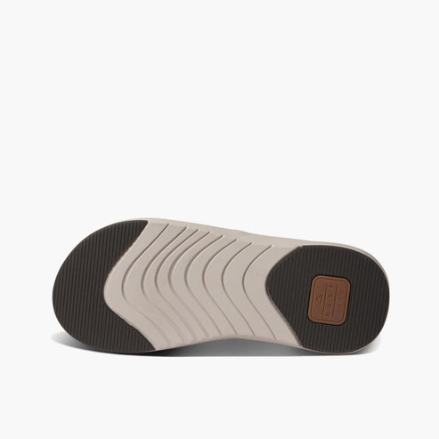 Bottom view of sandal with wavy lines and dark brown heel and toe.