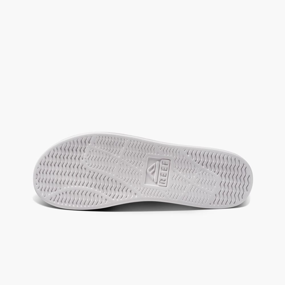 White shoe sole with REEF logo and wave-patterned texture.