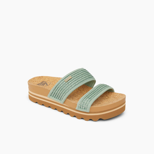Two-strap platform sandal with light green, textured straps and cork sole.