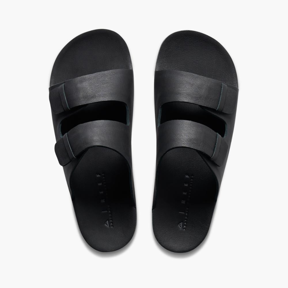 A pair of black slide sandals with two straps each.