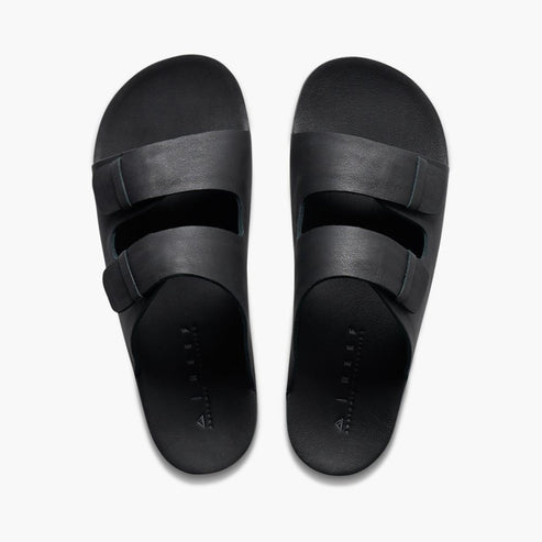 A pair of black slide sandals with two straps each.