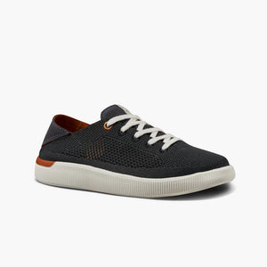 Charcoal gray knit sneaker with white laces, white sole, and a touch of orange trim.