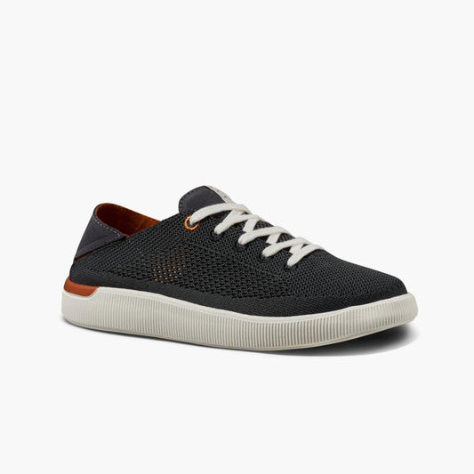 Charcoal gray knit sneaker with white laces, white sole, and a touch of orange trim.