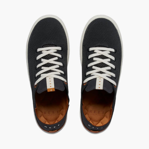 A pair of low-top knit sneakers with white laces.