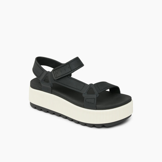 Black platform sandal with hook and loop straps.