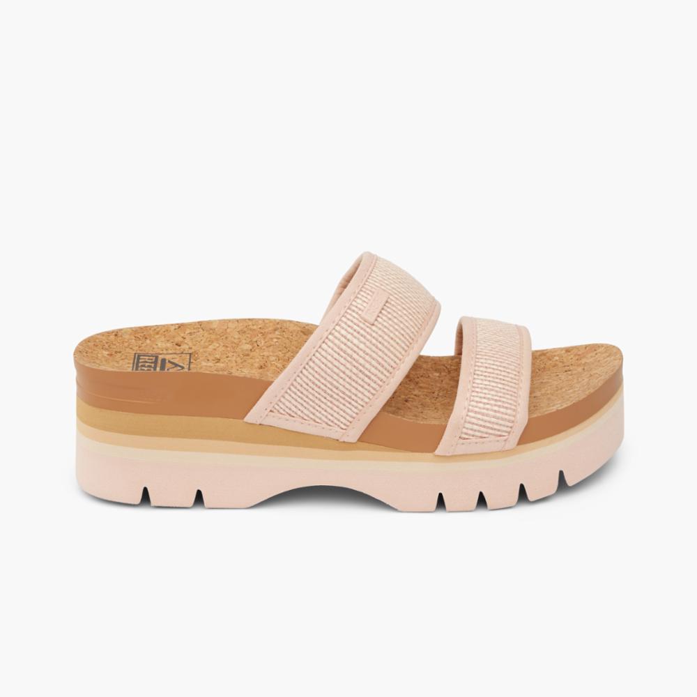 Platform slide sandals with two pink straps, cork footbed and pink lug sole.
