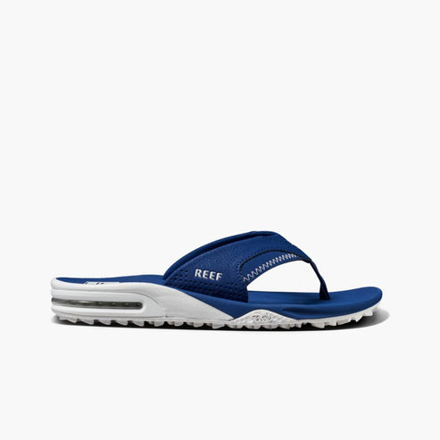 Side view of blue REEF sandals with white midsoles.