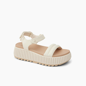 White platform sandal with velcro straps.