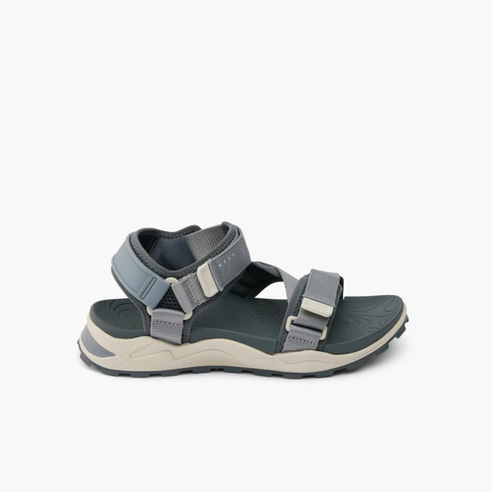 Gray sandal with straps and buckle.