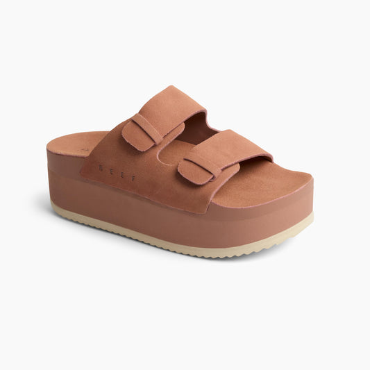 Peach sandal with two buckled straps and a thick sole.
