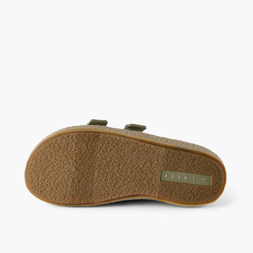 Bottom view of a fuzzy, olive-green sandal with a ridged, brown sole.