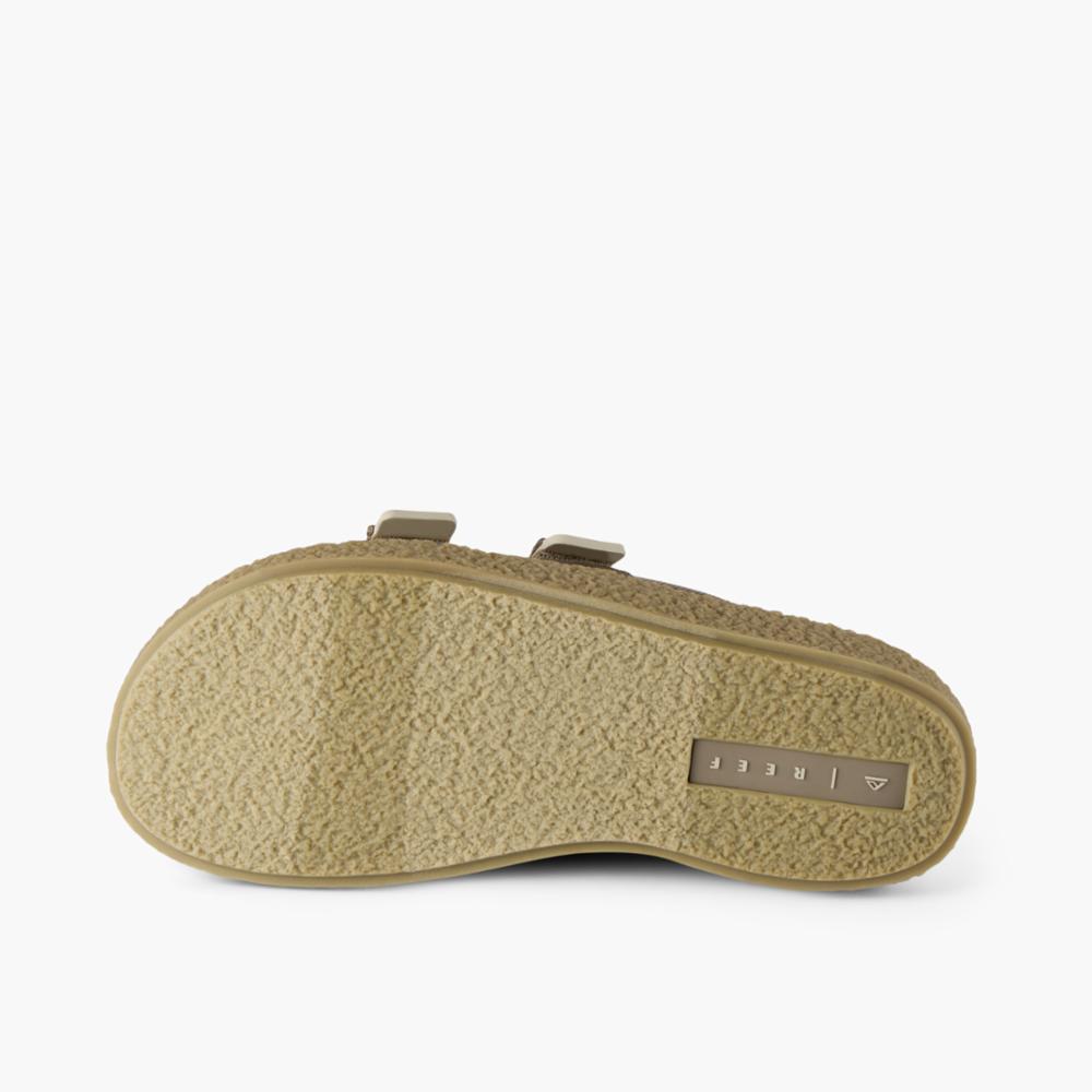 Beige sandal's sole with two tan straps.