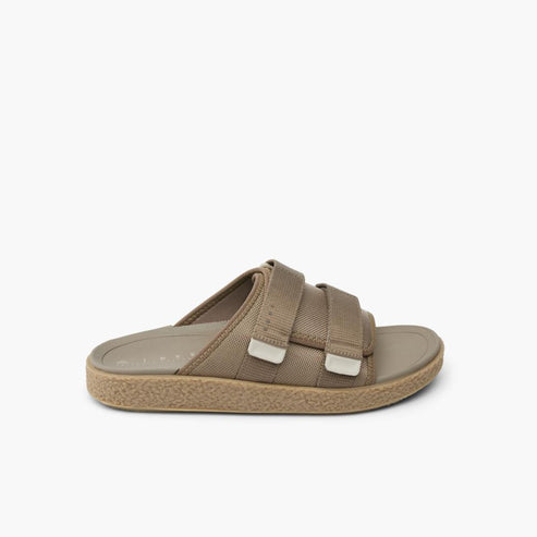 Tan sandal with velcro straps and a textured sole.