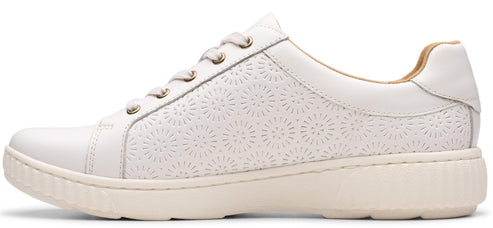 A white leather sneaker with decorative perforations.