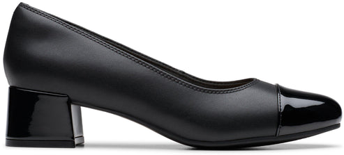 A black leather women's low-block heel pump shoe with a glossy patent leather toe cap and a matching glossy block heel, shown in a side profile view.
