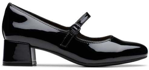 A black patent leather Mary Jane shoe with a low, block heel and a slim buckled strap across the instep.