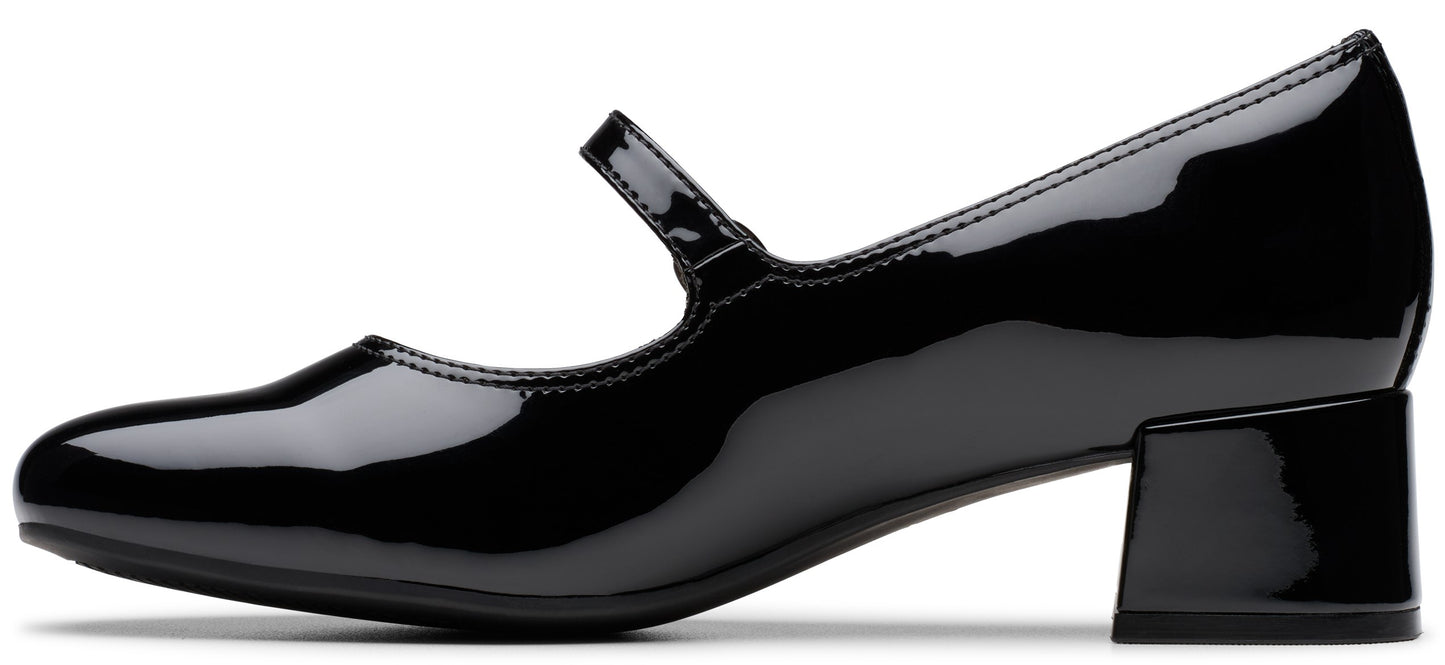 A black patent leather Mary Jane shoe with a low block heel and a single strap across the instep, shown from the side profile.