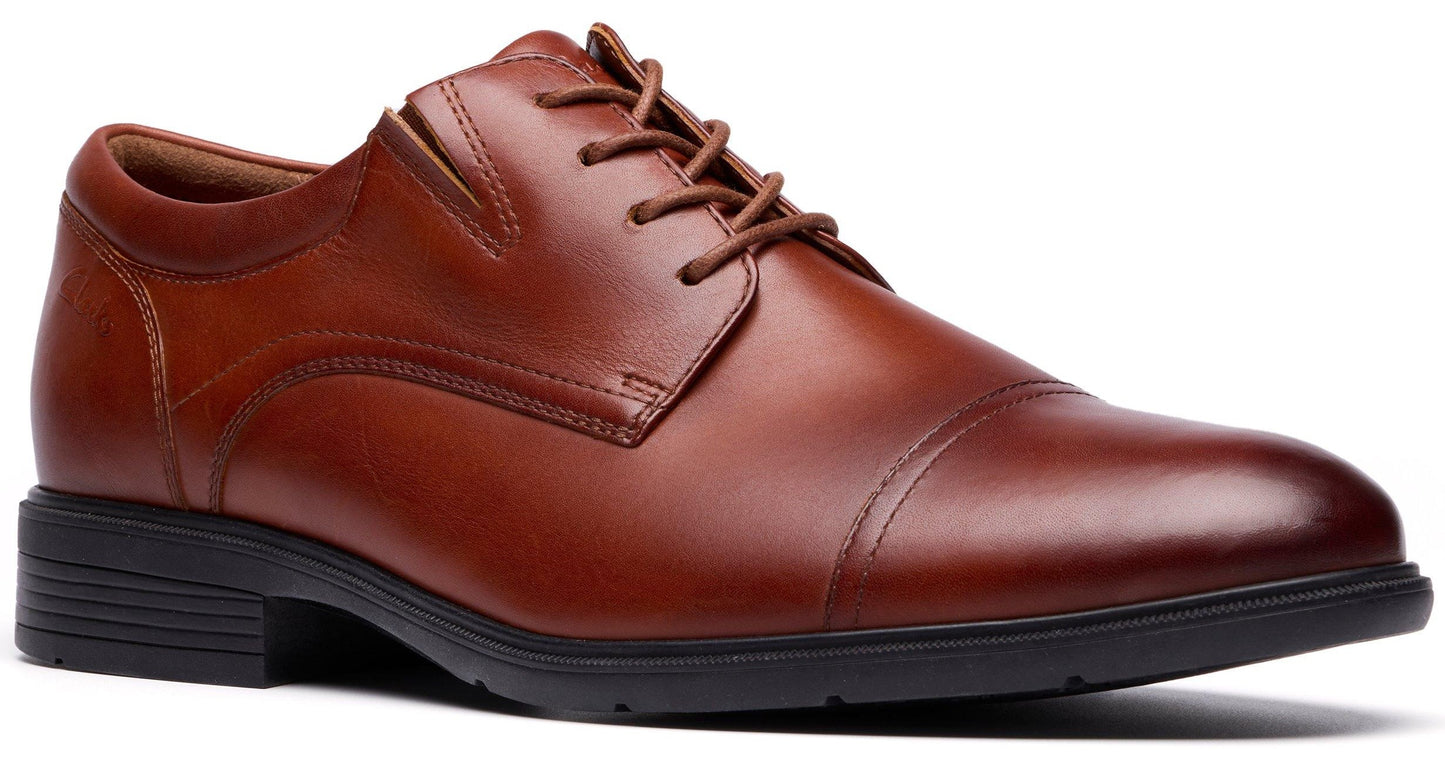 Brown leather cap-toe oxford shoe with dark sole and laces.