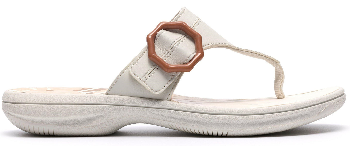 Off-white sandal with a decorative buckle.