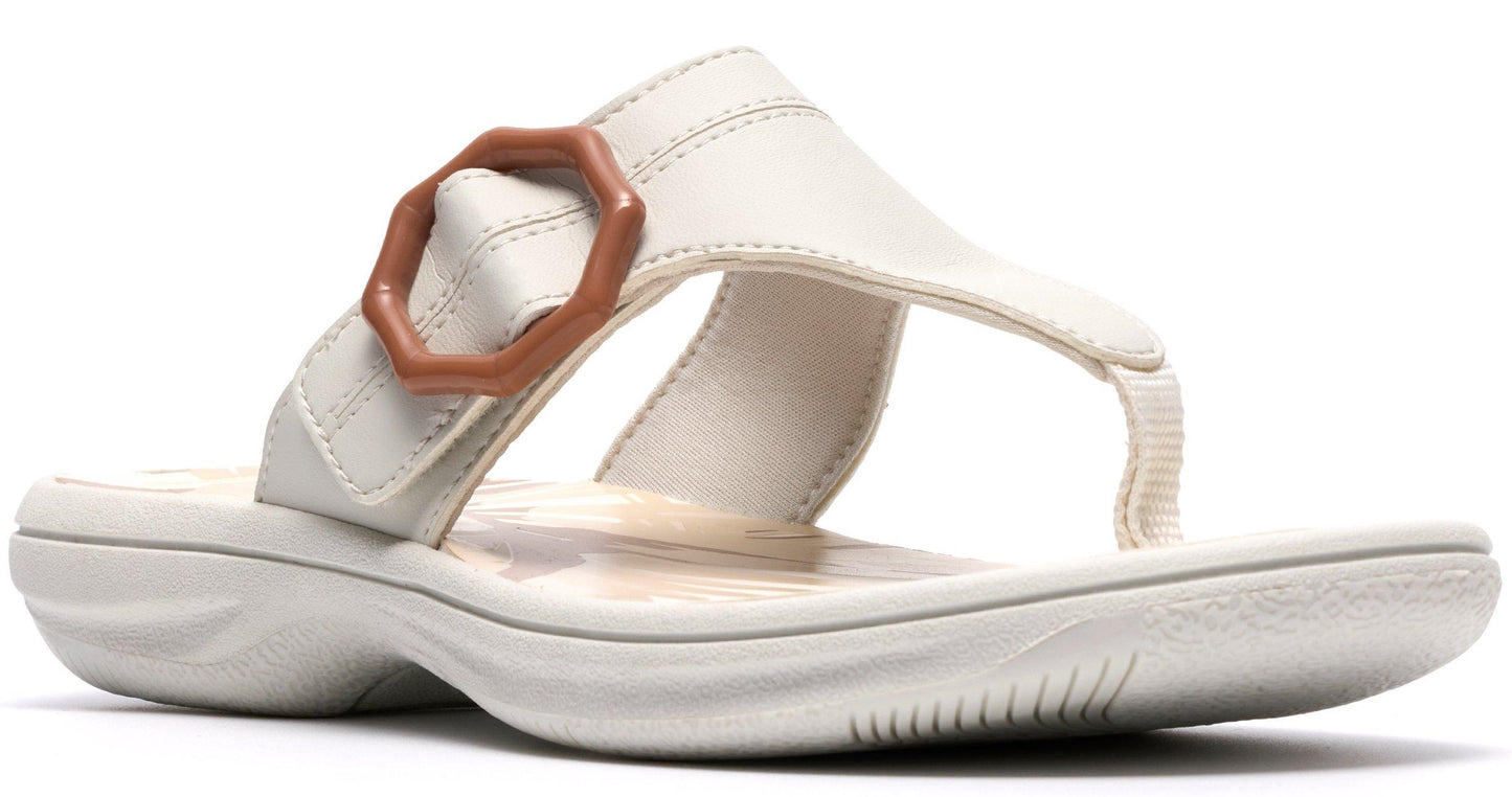 A sandal with a toe post and a large, brown, geometric buckle on the side.