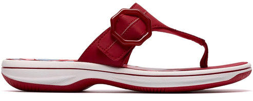 Red sandal with a decorative buckle.