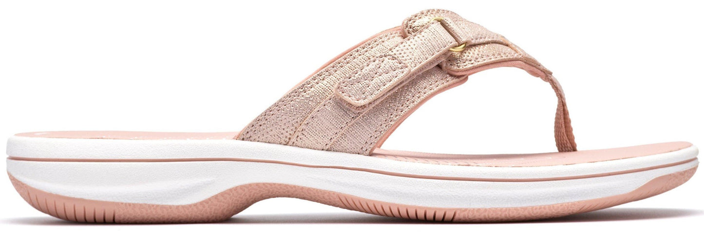 A pink flip-flop with an adjustable strap.