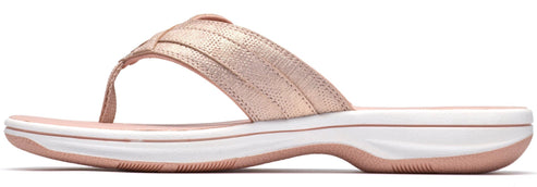 Rose gold sandal with a thong toe and a flat sole.