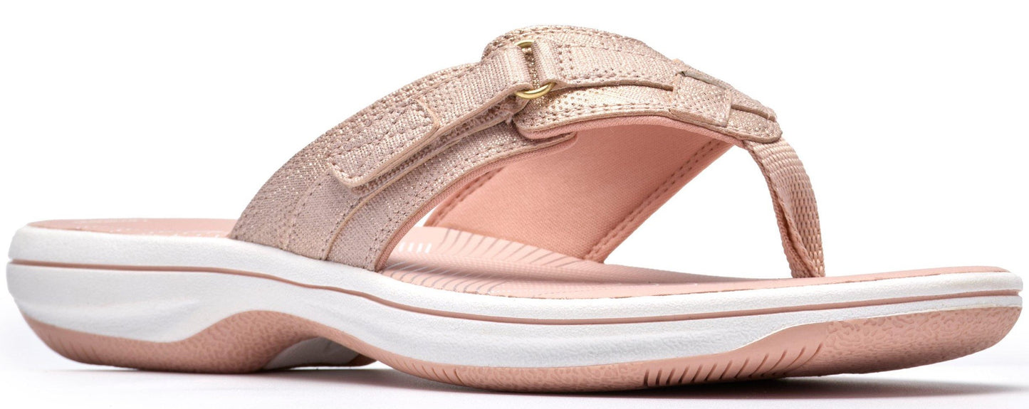 A rose gold sandal with white sole.