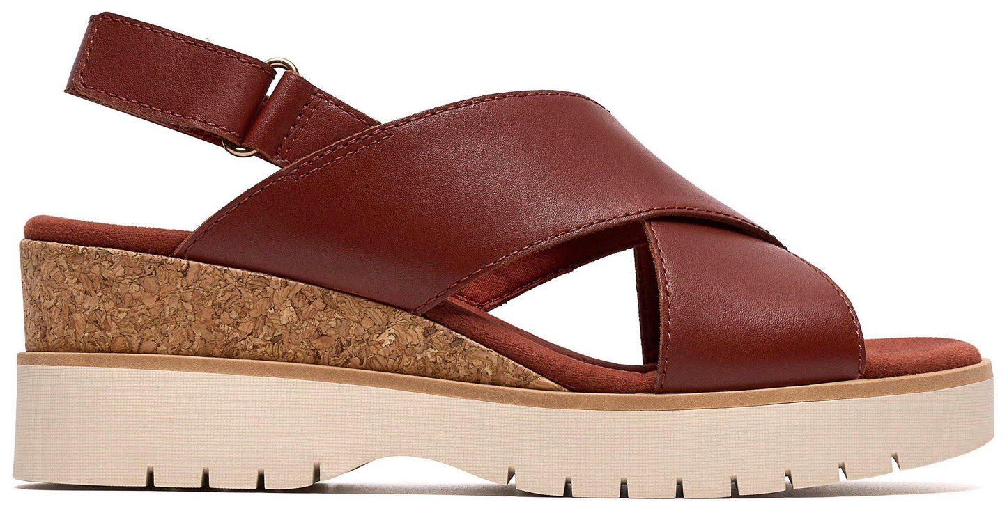 Red leather sandals with criss-cross straps, cork wedge, and cream platform sole.