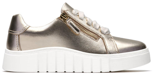 A gold-colored sneaker with a white sole, a side zipper, and white laces.
