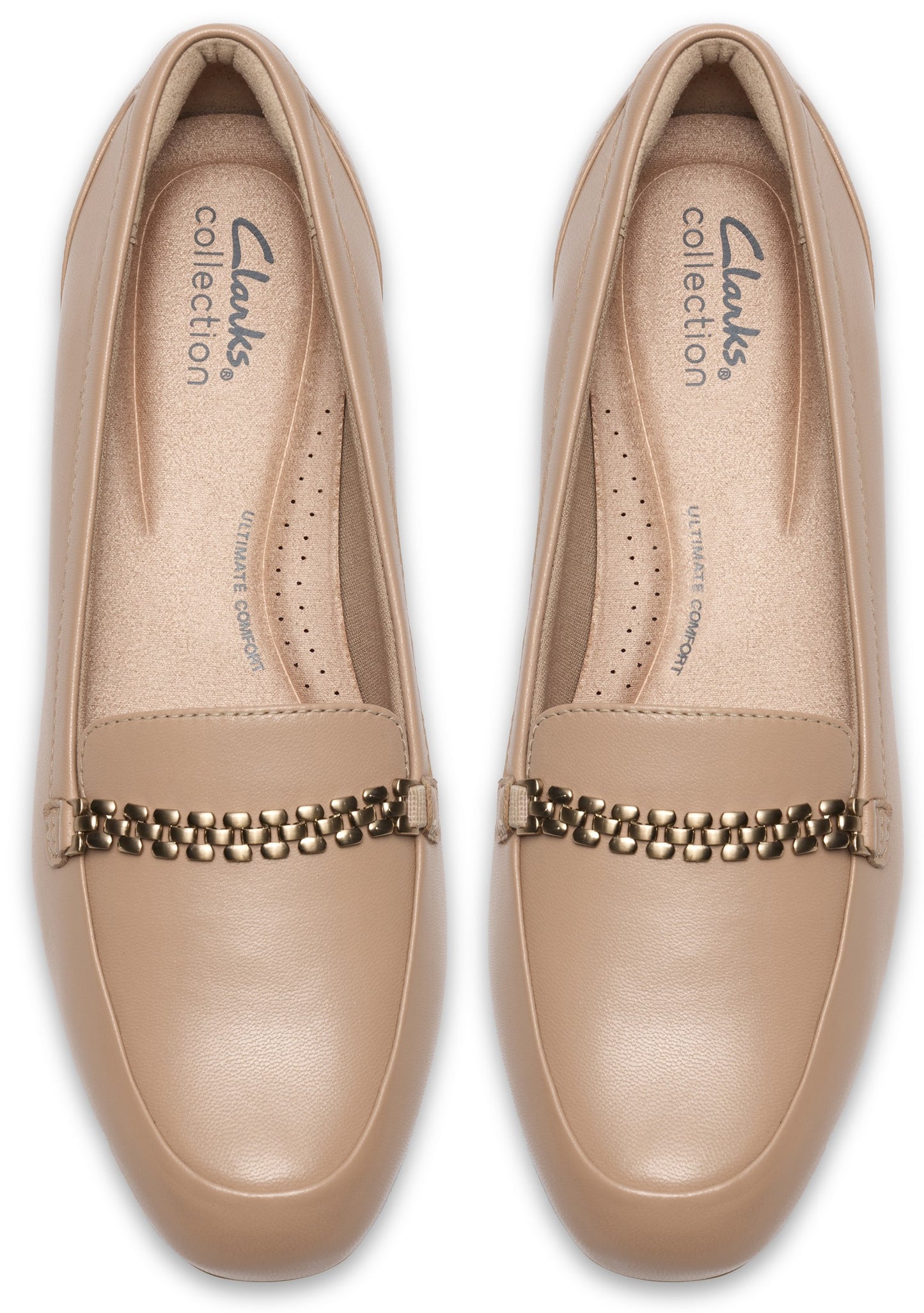 A pair of nude-colored, leather slip-on loafers, viewed from a top-down angle, featuring a metallic chain-link detail across the instep and 'Clarks Collection' branding printed on the cushioned insole.