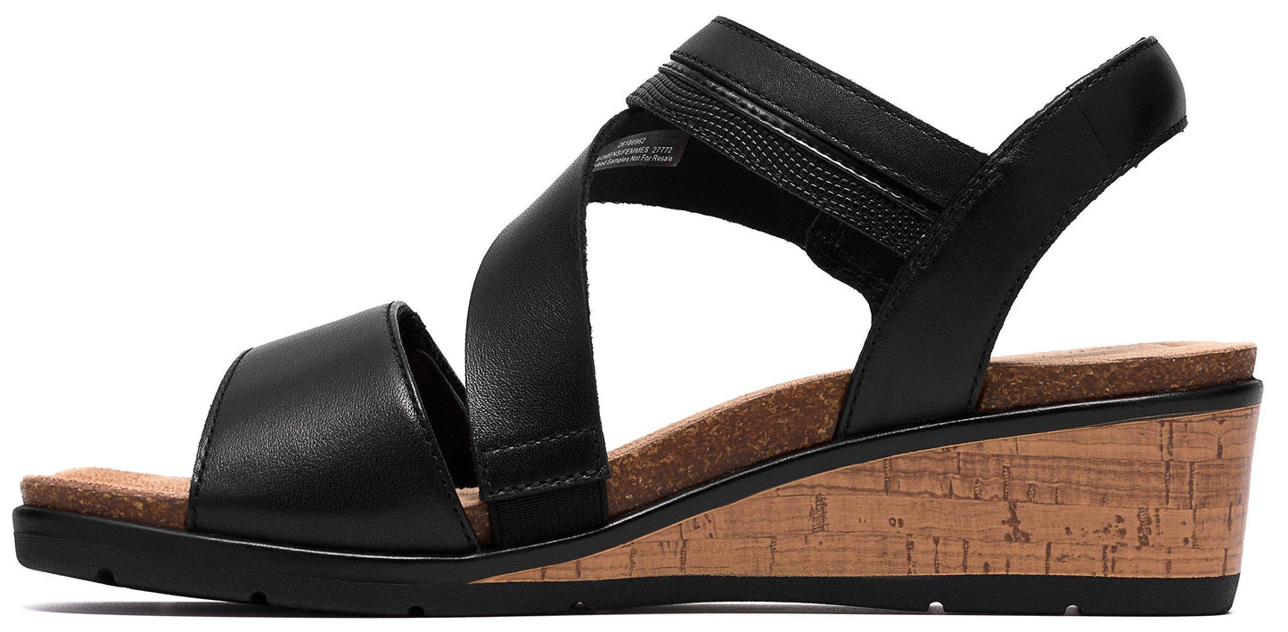 A black wedge sandal with a crisscross design.