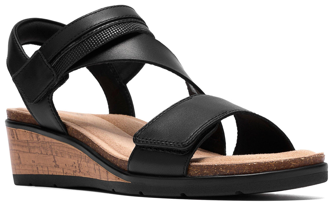 Black wedge heel sandal with two straps and adjustable velcro closure.
