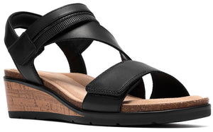Black wedge heel sandal with two straps and adjustable velcro closure.