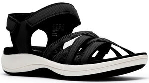 A women's sandal with an adjustable velcro heel strap and multiple crossing black straps over the toes on a white sole.