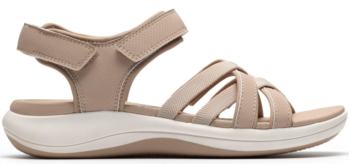 A beige sandal with multiple straps and an adjustable velcro strap.