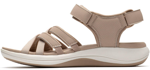 A beige sandal with adjustable straps and a white sole.