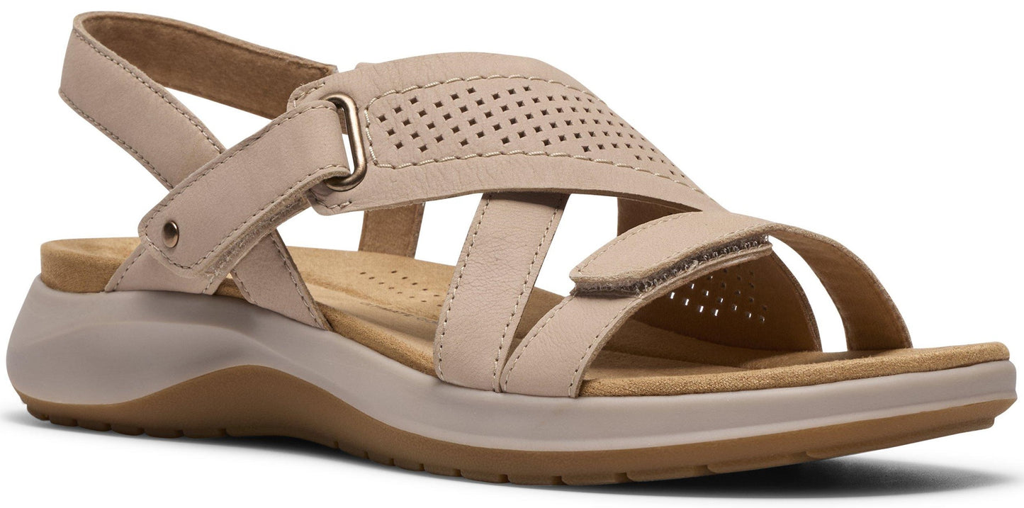 Beige sandal with adjustable straps and a perforated design.