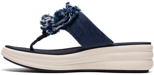 A sandal with a blue denim strap and a denim flower accent.