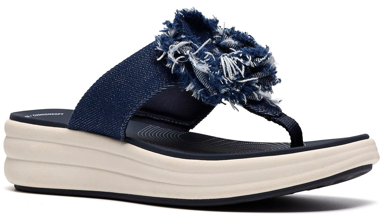 A platform sandal in denim, with a flower shaped denim decoration, in a thong style.