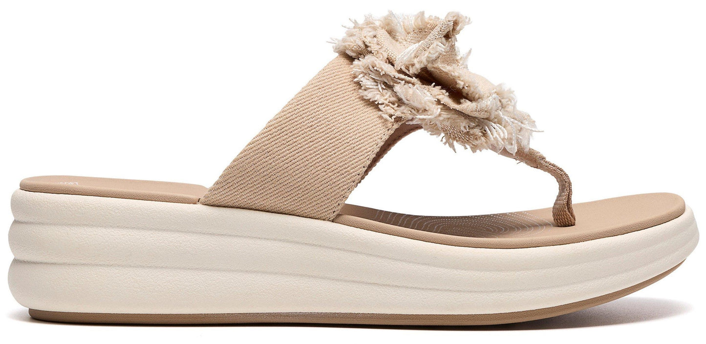 A beige platform sandal with a decorative fabric flower.