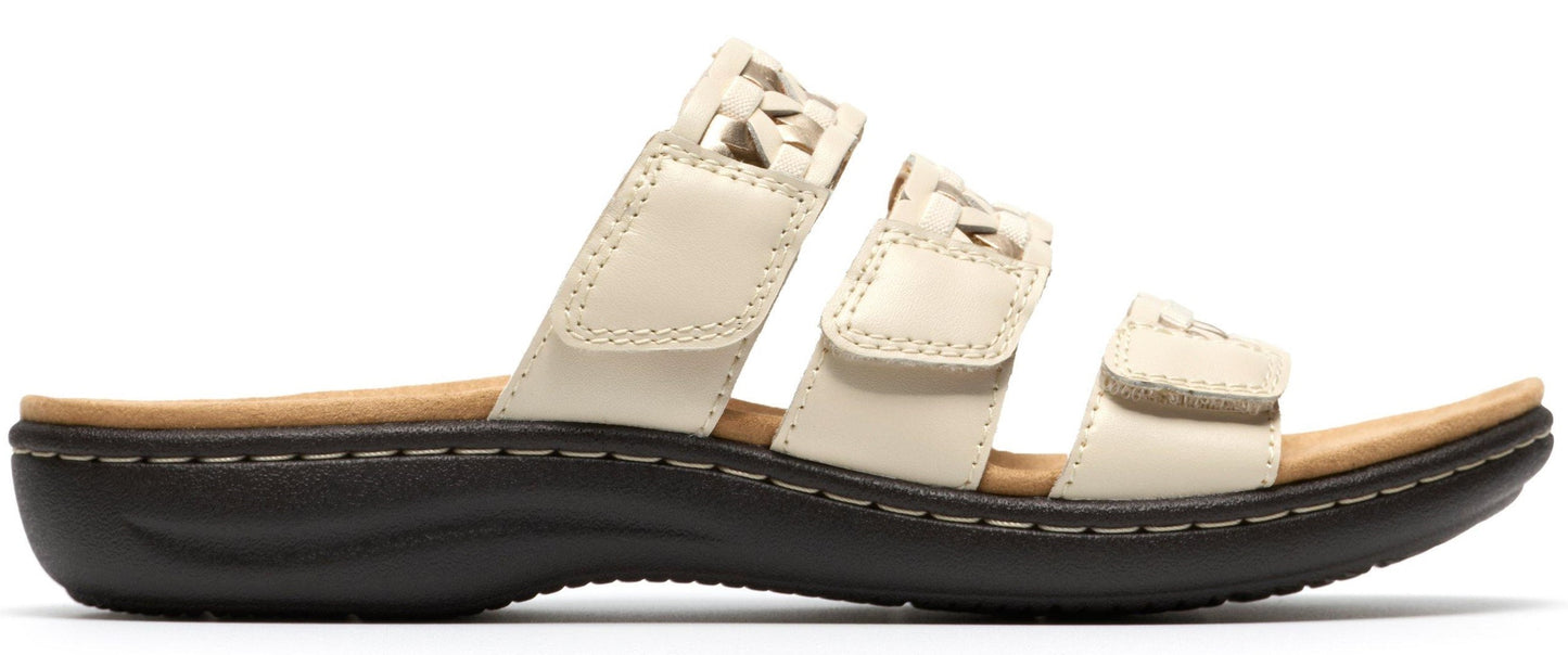A white sandal with three straps.