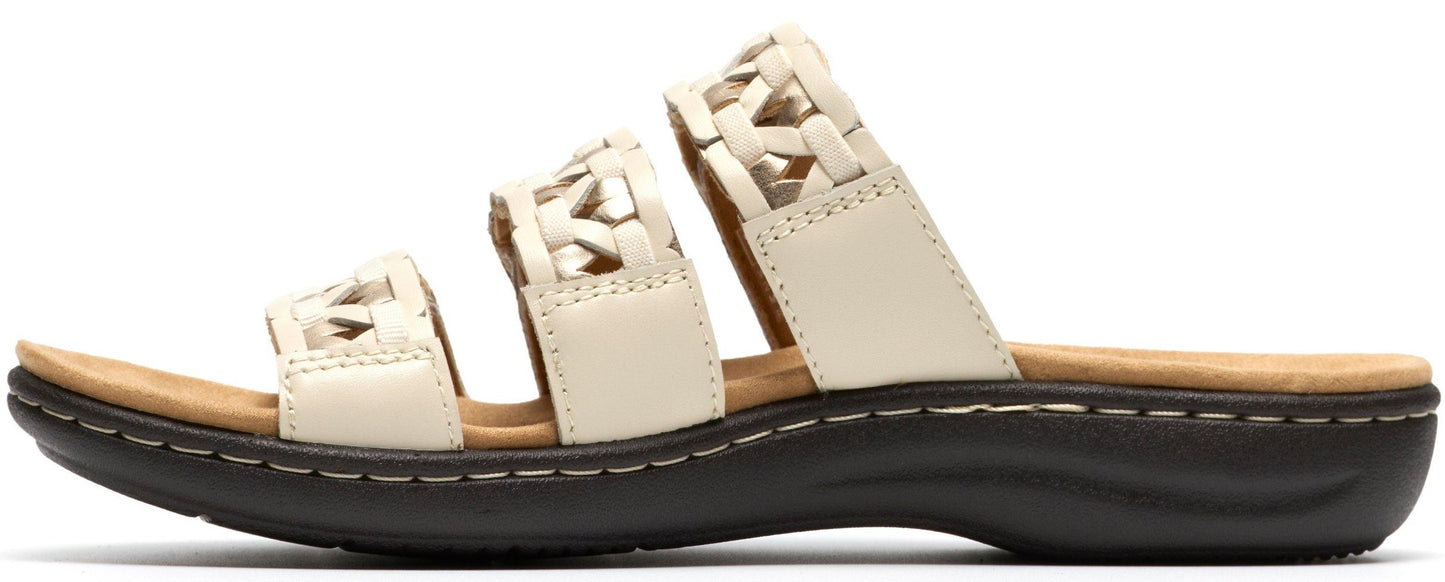 A white sandal with three straps.