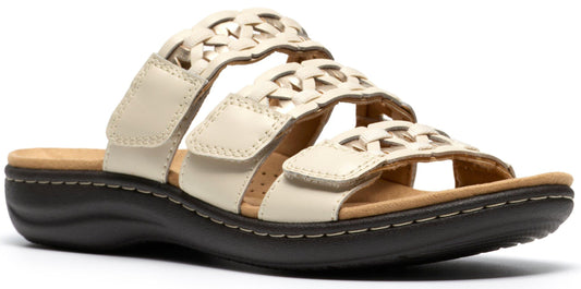 Off-white sandal with three straps, each with a woven design and velcro closure.