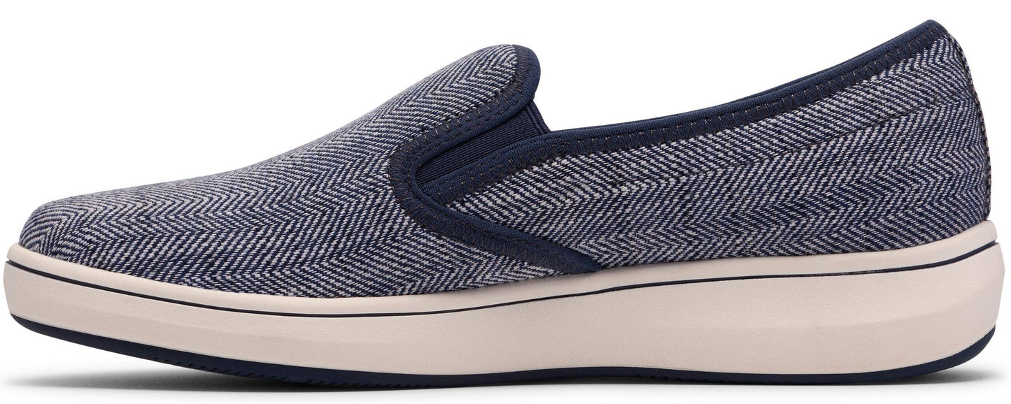A slip-on shoe with blue and white herringbone pattern fabric on a beige sole.