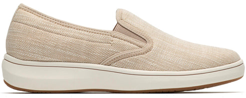 A slip-on sneaker with a tan canvas upper and a thick white sole.