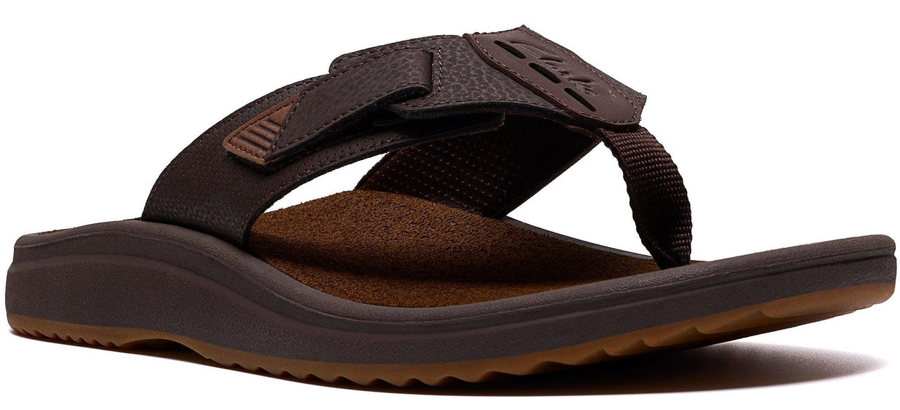 A brown sandal with a thick sole and a toe post.