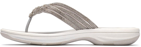 A white women's sandal with a beaded strap.